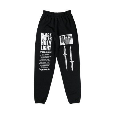 a pair of black sweat pants with white text and a picture on it